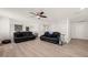 Open living area with contemporary flooring and multiple seating options for entertaining at 6633 Penfield St, Wake Forest, NC 27587