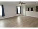 Spacious living room featuring modern vinyl floors, accent wall, and plenty of natural light at 6633 Penfield St, Wake Forest, NC 27587