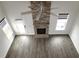 Bright living room featuring a stone fireplace, high ceilings, and large windows at 6633 Penfield St, Wake Forest, NC 27587