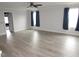 Spacious living room with hardwood floors and natural light from large windows at 6633 Penfield St, Wake Forest, NC 27587