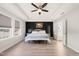 Bedroom featuring a tray ceiling, ceiling fan, and a large window at 6633 Penfield St, Wake Forest, NC 27587