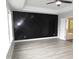 Spacious bedroom with hardwood floors and a black accent wall at 6633 Penfield St, Wake Forest, NC 27587