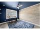 Room featuring a large window, ceiling fan, and a dark blue accent wall at 6633 Penfield St, Wake Forest, NC 27587