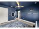 Room showcasing dark blue walls, view of a door leading to another room and a blue patterned rug at 6633 Penfield St, Wake Forest, NC 27587