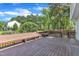 Spacious wooden deck featuring a bench, fire pit, and a view of the landscaped backyard at 7 Bonham Ct, Durham, NC 27703