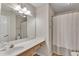 Full bathroom features a shower with curtain, single sink vanity, and linoleum flooring at 7 Bonham Ct, Durham, NC 27703