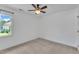 Neutral bedroom with a ceiling fan and a window bringing in natural light at 7 Bonham Ct, Durham, NC 27703