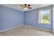 Cozy bedroom features a ceiling fan, neutral carpet and good natural light at 7 Bonham Ct, Durham, NC 27703