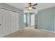 Bedroom has light blue walls, ceiling fan, closet and neutral carpet at 7 Bonham Ct, Durham, NC 27703