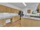 Bright kitchen with light wood cabinets, white counters, hardwood floors, and modern stainless-steel appliances at 7 Bonham Ct, Durham, NC 27703