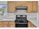 Bright kitchen features stainless steel gas range, light wood cabinets, and white countertops at 7 Bonham Ct, Durham, NC 27703