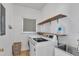 Functional laundry room is equipped with shelving and modern washer and dryer units at 7 Bonham Ct, Durham, NC 27703