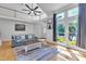 Bright and airy living room with hardwood floors, large windows, and a comfortable seating area with nice rug at 7 Bonham Ct, Durham, NC 27703