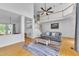 Bright and airy living room with hardwood floors, high ceilings, and comfortable seating area with staircase in view at 7 Bonham Ct, Durham, NC 27703
