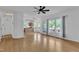 Open-concept living room has hardwood floors, ceiling fan, and lots of natural light at 7 Bonham Ct, Durham, NC 27703