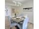 Elegant dining room features modern light fixture and table setting for four, bathed in natural light at 707 Wade Ave, Raleigh, NC 27605