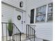 Inviting front porch with a modern door, black railing, and well-kept landscaping, creating curb appeal at 707 Wade Ave, Raleigh, NC 27605