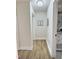 Bright hallway with wood-look floors and neutral paint leads to the bathroom at 707 Wade Ave, Raleigh, NC 27605