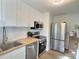 This modern kitchen features stainless steel appliances and ample counter space, perfect for cooking at 707 Wade Ave, Raleigh, NC 27605