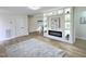 Bright living room features a modern fireplace with built-in display shelving and light hardwood floors at 707 Wade Ave, Raleigh, NC 27605