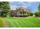 Expansive backyard showcasing a patio and beautifully landscaped greenery at 712 Evanvale Ct, Cary, NC 27518