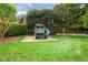 Large, well-maintained backyard with a custom playset, ideal for outdoor activities at 712 Evanvale Ct, Cary, NC 27518