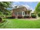 Backyard view with a well-kept lawn, patio, and mature trees, perfect for relaxing at 712 Evanvale Ct, Cary, NC 27518