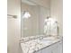 Close-up on the bathroom vanity featuring granite countertops and modern light fixtures at 712 Evanvale Ct, Cary, NC 27518