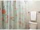 Bathroom with floral shower curtain, white tile, and towel rack at 712 Evanvale Ct, Cary, NC 27518