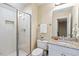 Bright bathroom with a glass shower door, granite countertops, and modern fixtures at 712 Evanvale Ct, Cary, NC 27518