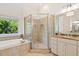 Bright bathroom with a granite vanity and a glass enclosed shower with tile surround at 712 Evanvale Ct, Cary, NC 27518