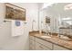 Bathroom with a granite vanity top, decorative mirror and framed artwork at 712 Evanvale Ct, Cary, NC 27518