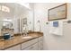 Bathroom with a granite vanity top, decorative mirror and framed artwork at 712 Evanvale Ct, Cary, NC 27518