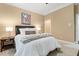 This bedroom has neutral colors, a bedside table and lamps, and the doorway visible in the back at 712 Evanvale Ct, Cary, NC 27518