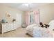 Bedroom with pink curtains, white dresser, and bed with rainbow comforter at 712 Evanvale Ct, Cary, NC 27518