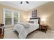 Cozy bedroom featuring a plush bed, neutral walls, and abundant natural light from the window at 712 Evanvale Ct, Cary, NC 27518