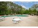 Large community pool surrounded by trees and lounge chairs at 712 Evanvale Ct, Cary, NC 27518