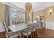 Elegant dining room featuring a decorative chandelier and large window providing natural light at 712 Evanvale Ct, Cary, NC 27518