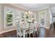 Sunlit dining area showcases a wooden table, white chairs, and large windows with natural light at 712 Evanvale Ct, Cary, NC 27518