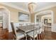 An elegant dining room features a decorative chandelier, wooden table, and views into other rooms at 712 Evanvale Ct, Cary, NC 27518