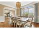 An elegant dining room features a decorative chandelier, wooden table, and large windows at 712 Evanvale Ct, Cary, NC 27518