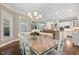 Open dining area features modern chandelier, wooden table, and bar seating nearby, great for gatherings at 712 Evanvale Ct, Cary, NC 27518