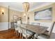 A traditional dining room features a wooden table with seating for six and a decorative chandelier at 712 Evanvale Ct, Cary, NC 27518