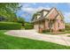 Beautiful brick home featuring a well-manicured lawn and a spacious driveway at 712 Evanvale Ct, Cary, NC 27518