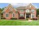 Beautiful brick home featuring a manicured lawn and an inviting, covered front entryway at 712 Evanvale Ct, Cary, NC 27518