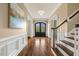 Entry foyer with hardwood floors, staircase, and arched openings to adjacent rooms at 712 Evanvale Ct, Cary, NC 27518