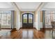 Spacious foyer with hardwood floors, white trim, and grand double door entrance at 712 Evanvale Ct, Cary, NC 27518