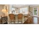 Bright kitchen with white cabinets, breakfast bar, and wicker bar stools at 712 Evanvale Ct, Cary, NC 27518
