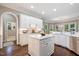 Kitchen boasts recessed lighting, stainless appliances, expansive countertops, and a large island for entertaining at 712 Evanvale Ct, Cary, NC 27518