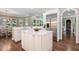 This kitchen features stainless appliances, white cabinets, and a large island, seamlessly connected to the dining area at 712 Evanvale Ct, Cary, NC 27518